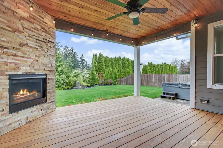 As you head out your enormous sliding patio doors to your refinished covered lanai, just pause and take it all in: Outdoor gas fireplace with floor-to-ceiling stonework, fan with stunning PNW wood ceiling, fully-fenced and professionally landscaped larger backyard with water feature and included newer hot tub and patio heater! WOW.