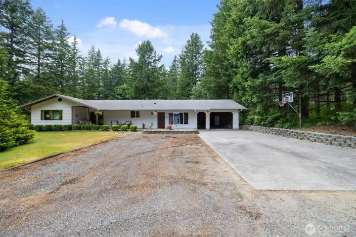 The single level home has a large (doorless) garage and a great area to shoot some hoops!