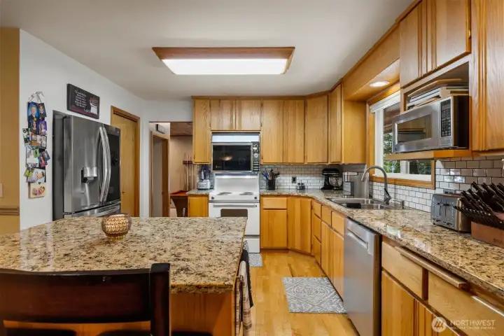 Another view of the kitchen with the large (new) refrigerator with the walk-in pantry to the right of it.