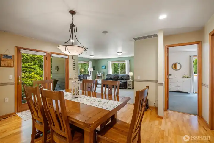 Looking across the dining room toward the living room and the primary suite to the right.