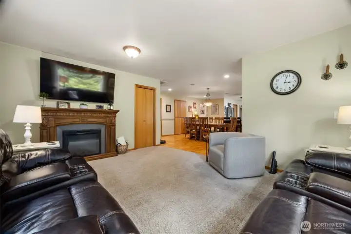 Looking across the living room toward the electric fireplace which will stay with the home.