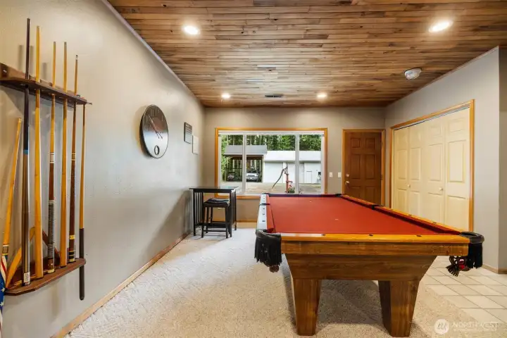 The family room is between the kitchen and the garage. It has a wood lined ceiling and a large game closet/storage. Many a good game of pool has been played here over the years.