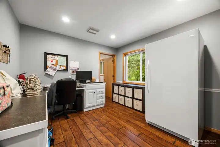 There is an office which was a hair salon not that long ago. This has laminate flooring and a 1/2 bath.