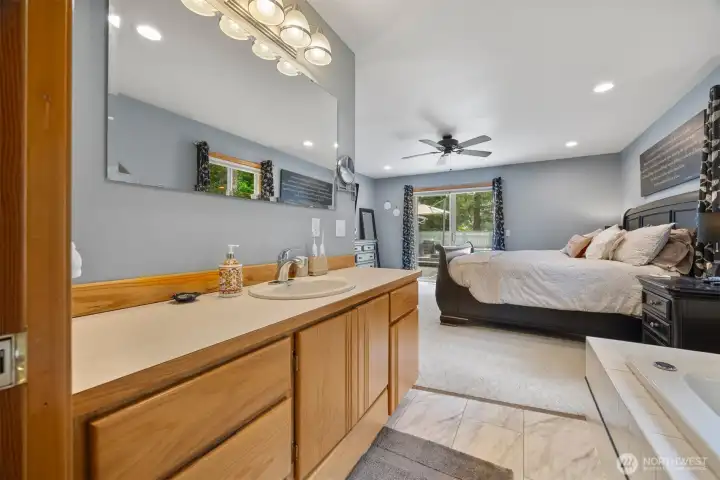 There is a very large single sink vanity with a lot of storage.