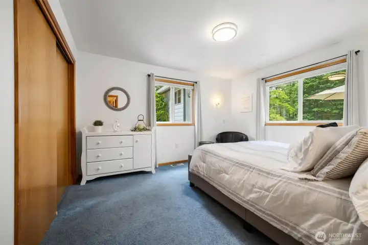 The second bedroom looks out toward the swimming pool.