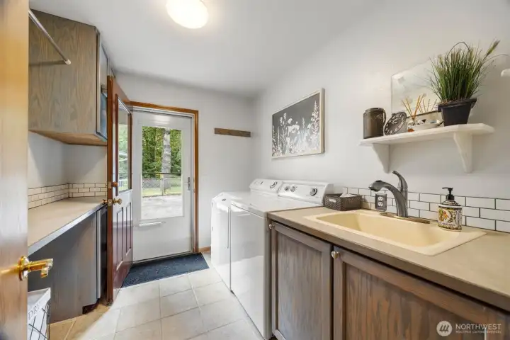 There is a laundry room that opens out to the patio by the swimming pool. There is a great hanging and folding space to the left.