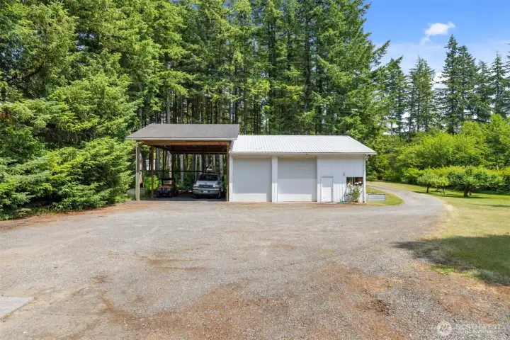 The carport can accommodate large RV's or vehicles. There are fruit trees across the driveway to the south of the shop.