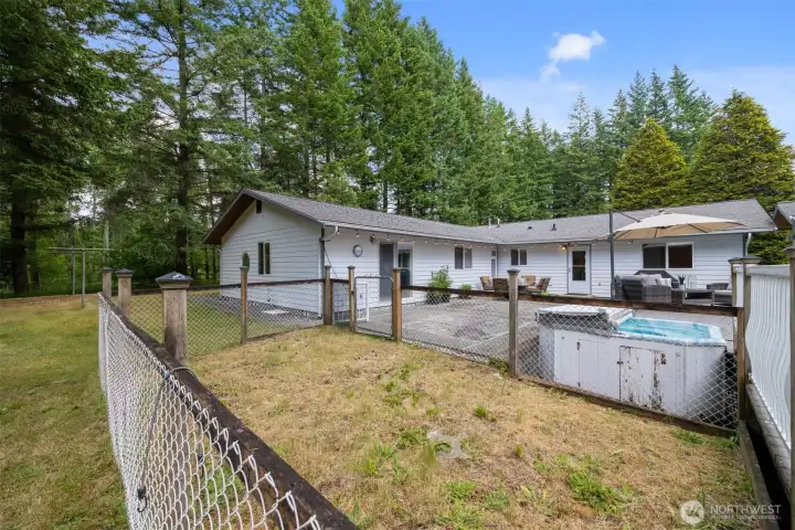 There is a full dog run just beyond the expansive patio and hot tub.