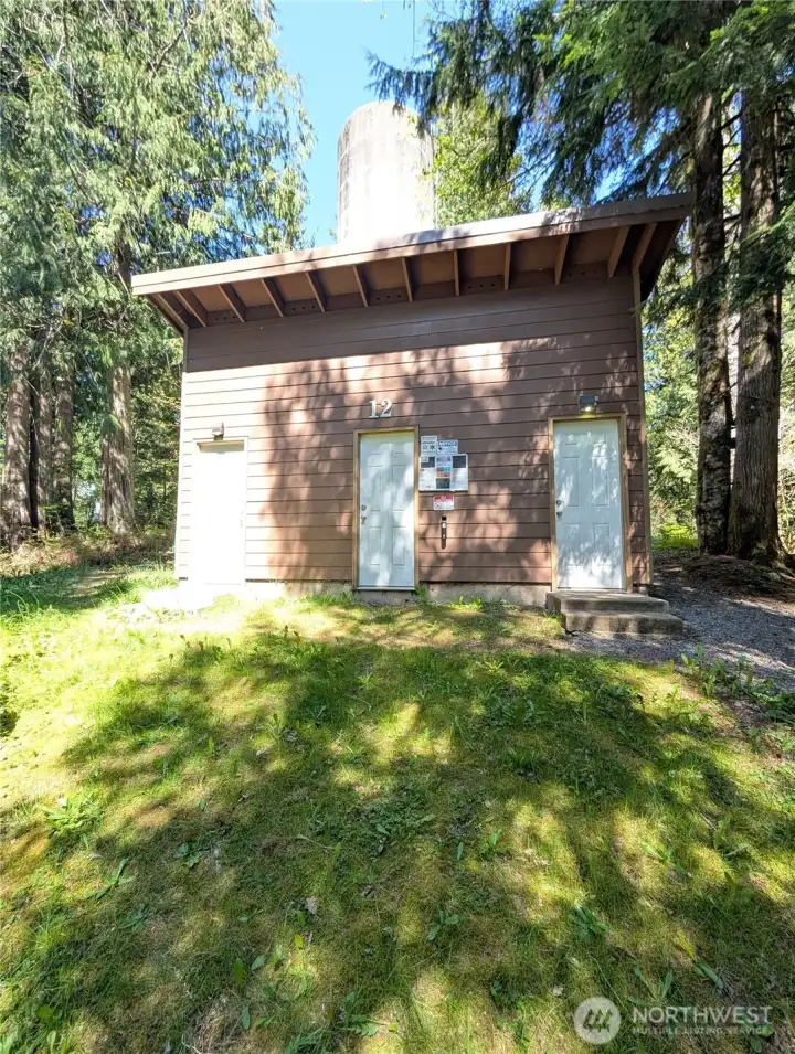 Super clean bathroom building w/ shower behind the property. Perfect for extra guests!