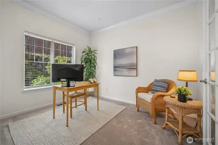 Just off the entry, the office or den features elegant French doors and a large picture window.