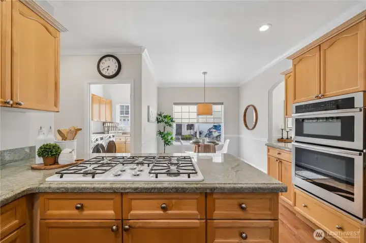 The kitchen features granite countertops, extensive cabinetry, a gas cooktop, and stainless-steel appliances replaced within the last three years.