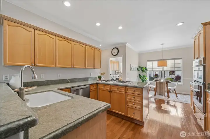 From here, you can appreciate how the kitchen opens to both the casual eating nook and the adjacent laundry room.