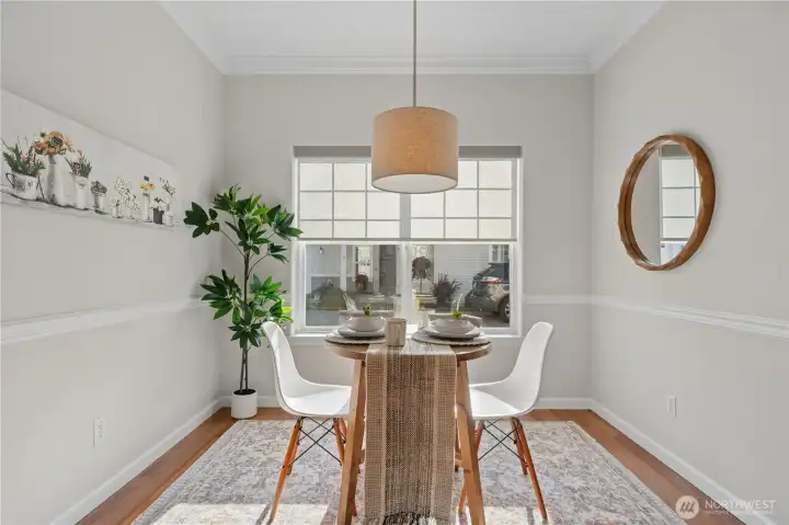 The charming eating nook, complete with a bay window and chair rail, is the perfect place for a quick meal, morning coffee, or game night with friends.