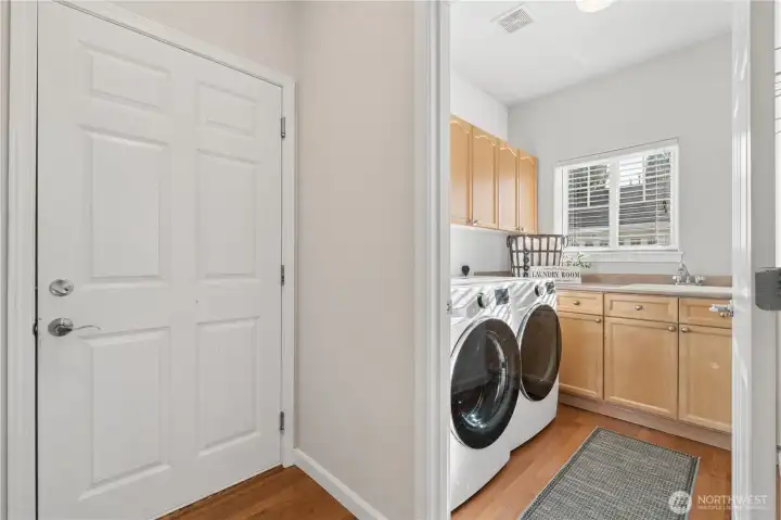 The laundry room features an LG washer and dryer, a utility sink, and additional storage space.