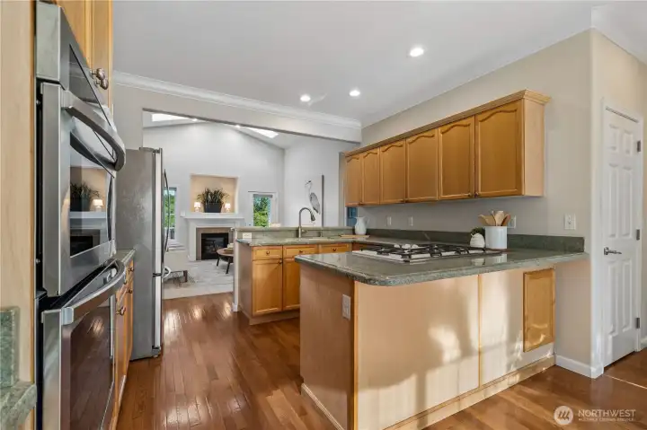 Here's another look at the kitchen and living area, showcasing the vaulted ceilings, skylights, and natural light that fills the home.