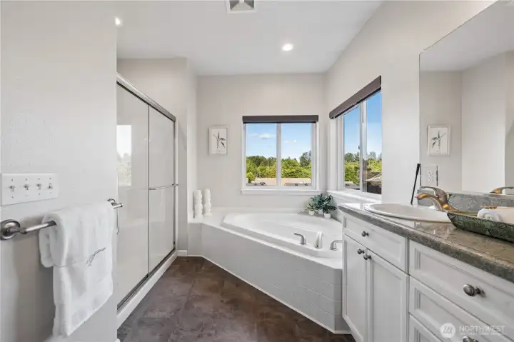Features include new CoreTec flooring, dual sinks, granite countertops, a soaking tub, walk-in shower, and large picture windows.