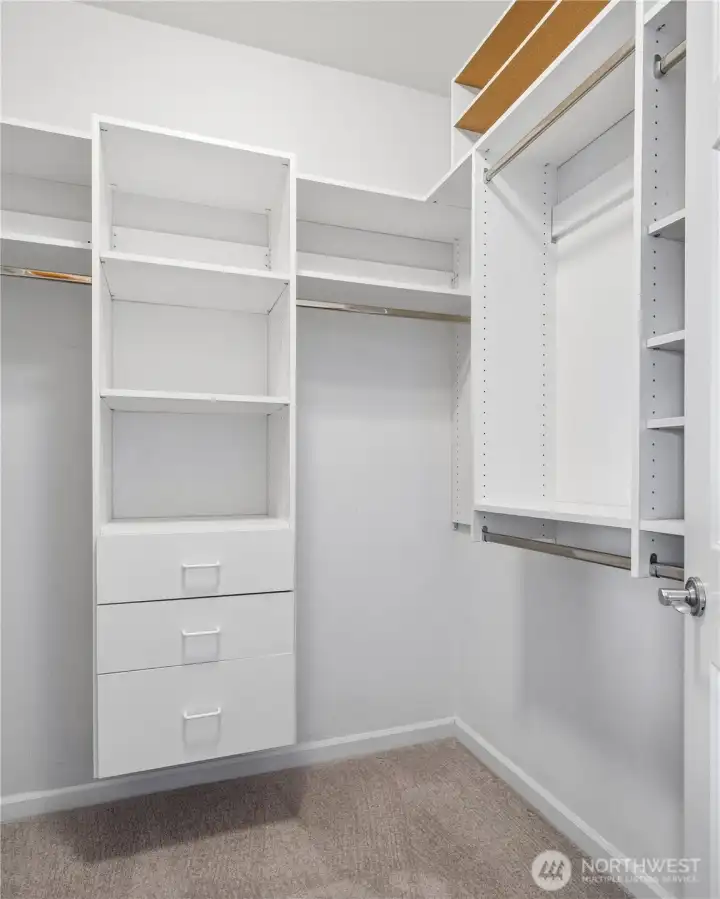 The walk-in closet includes a convenient organization system to maximize storage.