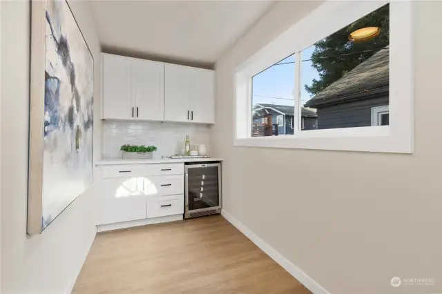 Here is your cool butlers pantry off kitchen with wine and drink fridge and more cabinets to store all your cooking needs