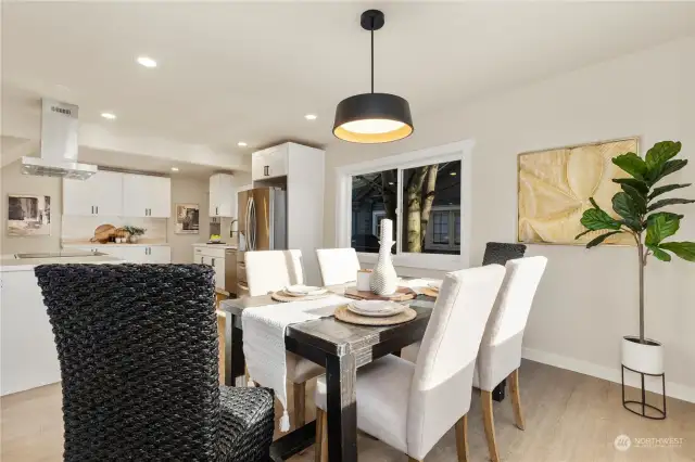 Here is view of good sized formal dining room looking back to large kitchen with lots of stylish colors and designs to enjoy here