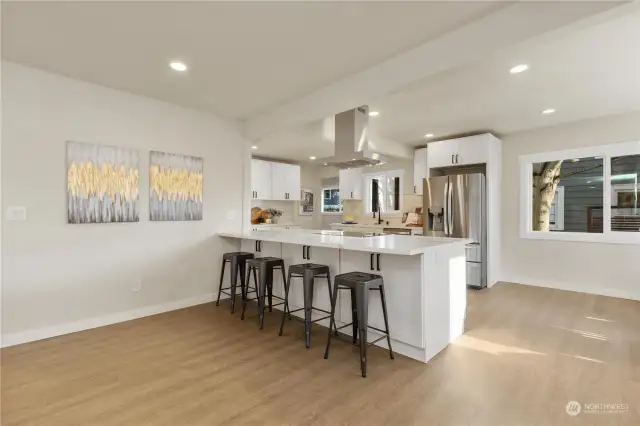 Kitchen view with earth tone colors high ceilings and lots of LVP flooring