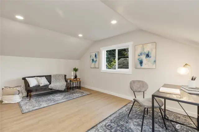 Check out this good sized sitting room upstairs off primary bedroom to enjoy working or relaxing just off your primary bedroom suite.  It has good sized ceilings recessed lighting and low maintenance LVP flooring to enjoy