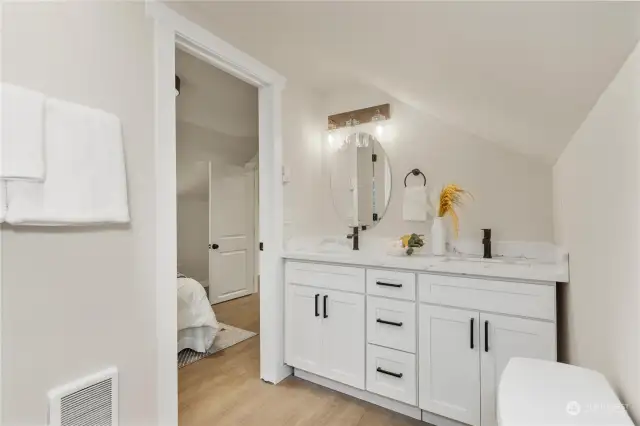 View of cute 4 piece primary bathroom with unique angles and designs surrounded by luxury designs
