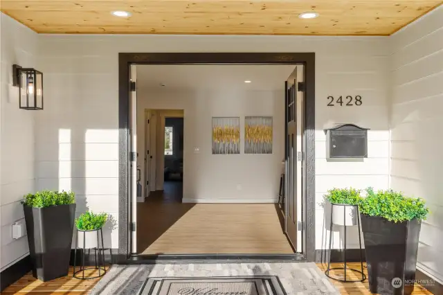 Stylish view of your new front entry of home with french doors covered front porch with recessed lighting and pine wood sofets to sit enjoy sunny afternoons on new front deck.  Come and see everything new inside