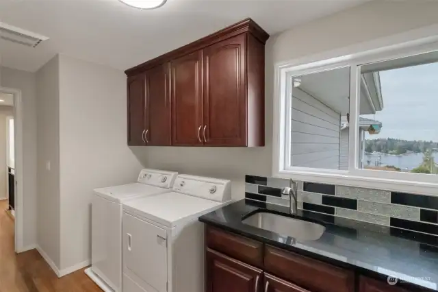 Lake Views even while doing the LAUNDRY! It doesn't get much better than this! Plenty of storage including hanging rack, utility sink, cabinetry and a built in ironing board.