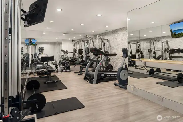 You'll be able to do all your favorite workout routines in this fitness room that also features a walk in safe behind the mirror