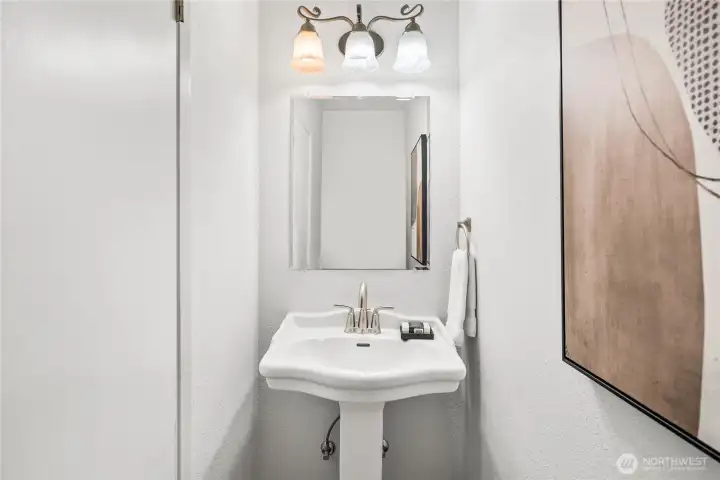 Half-bath with pedestal sink near the family room