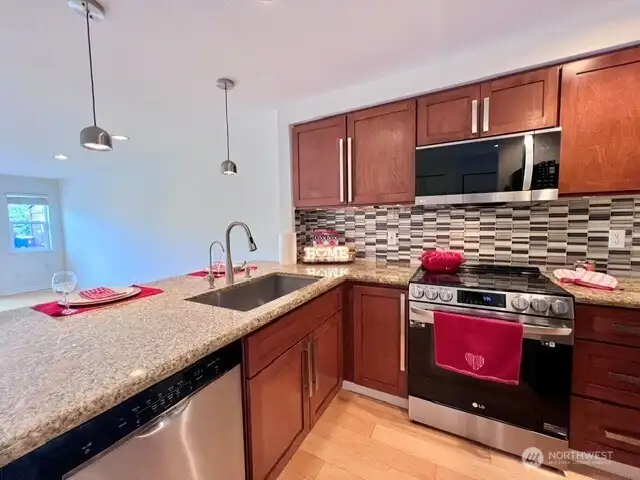 Granite countertops, glass tile backsplash