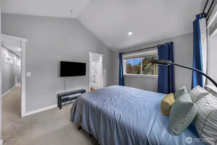 Another view of the primary suite showing the natural light and easy flow to the attached bathroom.