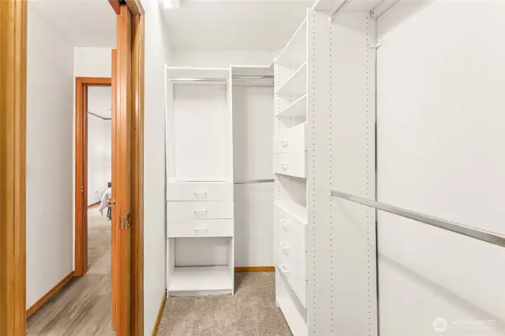 The custom walk-in closet offering plenty of shelves and drawers for effortless organization.