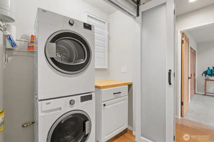 Opaque doors glide open to access the laundry area.