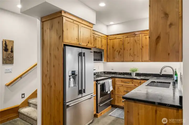 Kitchen with custom maple cabinets, granite counters and stainless appliances.