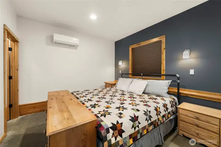 Main floor primary bedroom with king bed and mini split.