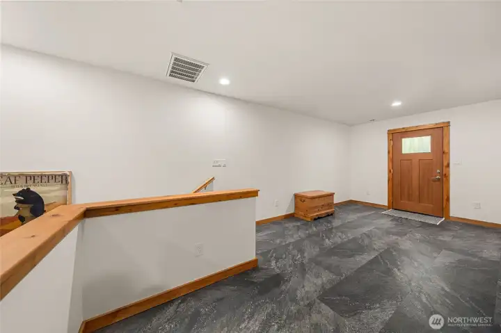 Spacious upper level entry area with door leading to back deck.