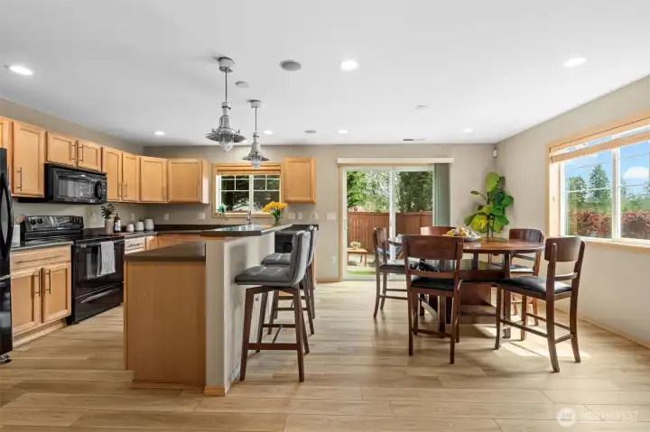 Experience true open concept living. This bright, airy kitchen and dining space transitions beautifully to the backyard sanctuary through oversized sliding glass doors