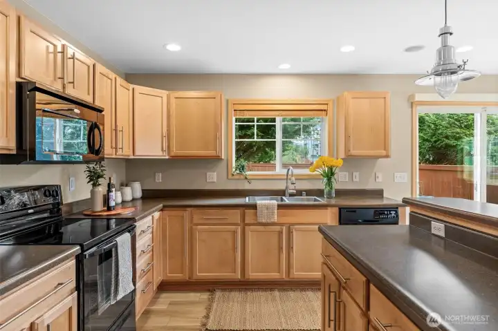 Culinary lovers will find comfort in this spacious kitchen with plenty of cabinetry storage and countertop space.