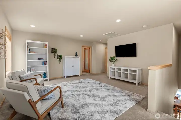 Discover the perfect 'bonus' room. This generous loft transformation provides a stylish transition between the upstairs bedrooms and serves as a central hub for evening relaxation