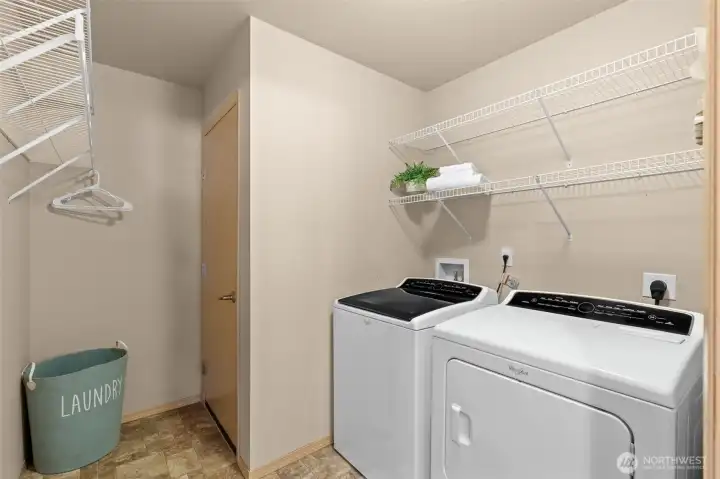 Laundry day simplified. This bright, dedicated workspace features modern appliances and plenty of room to stay organized