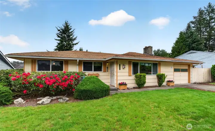 Spacious one-level home with a large front lawn, established landscaping, and an easy-flow layout designed for comfortable everyday living.