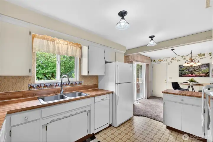 Large kitchen windows bring in natural light and provide peaceful backyard views while cooking and gathering