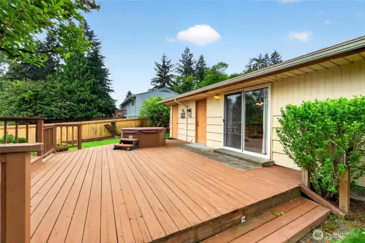 Large back deck extends the living space outdoors with easy access from the home and room for gatherings year-round.