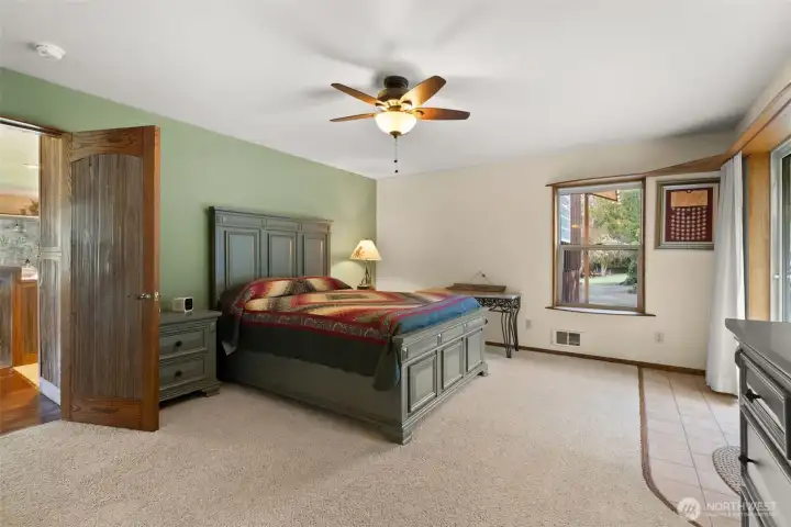 Comfortable primary suite with sliding glass door leading to a private back patio—perfect for enjoying peaceful mornings or evening relaxation.