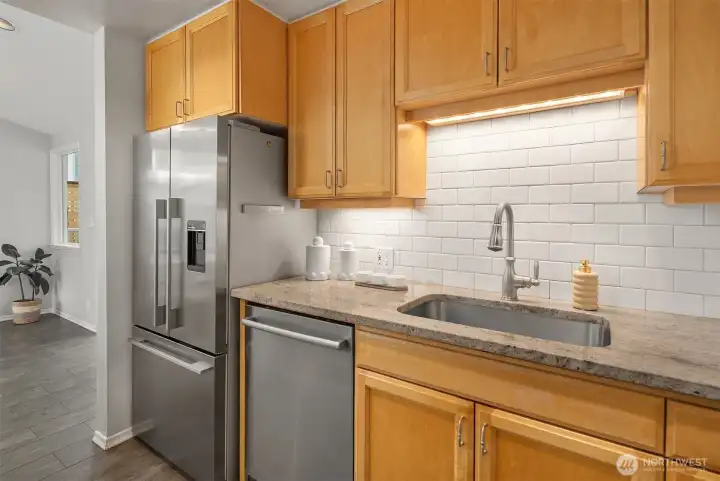 Kitchen with stainless appliances and subway tile detail