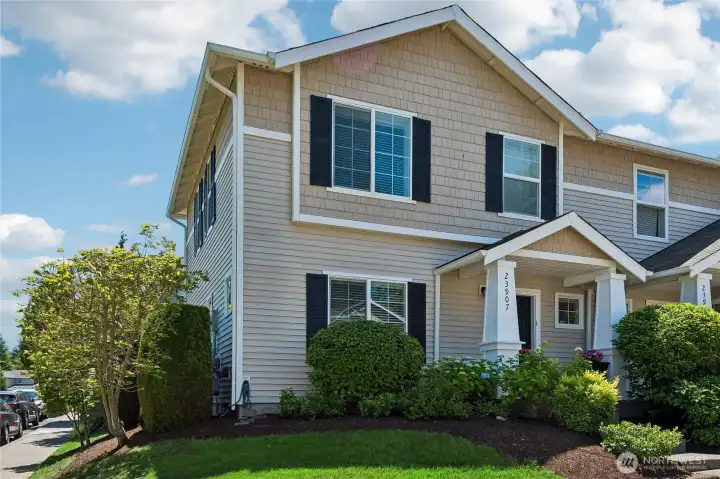 Inviting front exterior framed by new plantings and thoughtfully designed landscape upgrades.