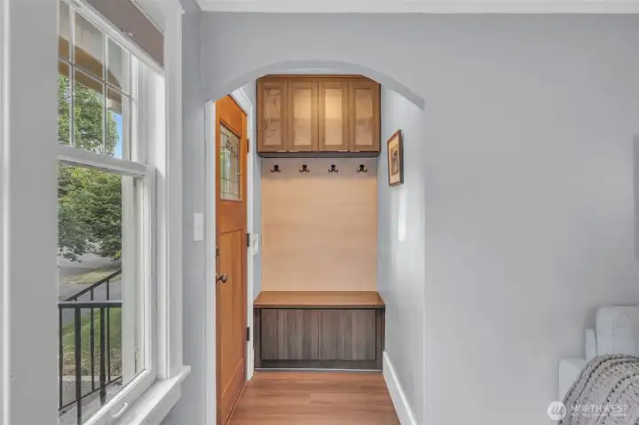 Entering the home, built-ins cabinetry and coat hooks provide the perfect drop spot.