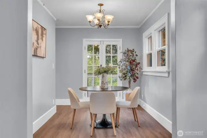 Light-filled dining space with French doors out to deck - perfect flow for summer entertaining!