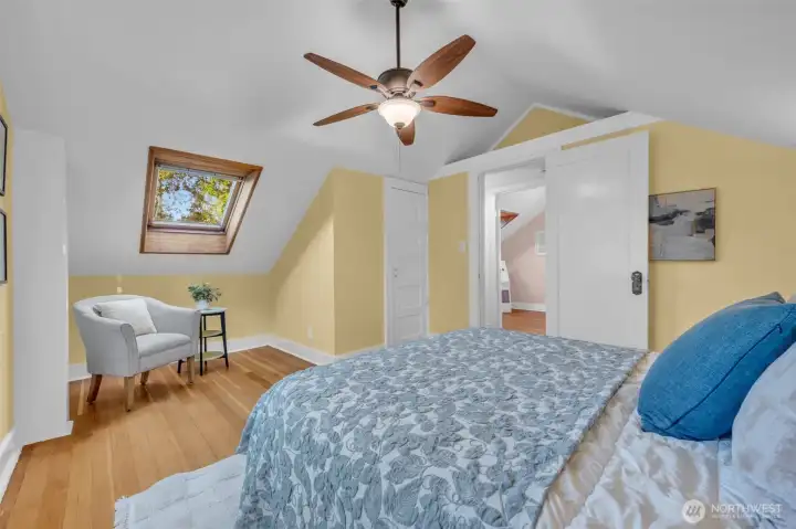 Upstairs find two bedrooms with vaulted ceilings, ceiling fans and skylights